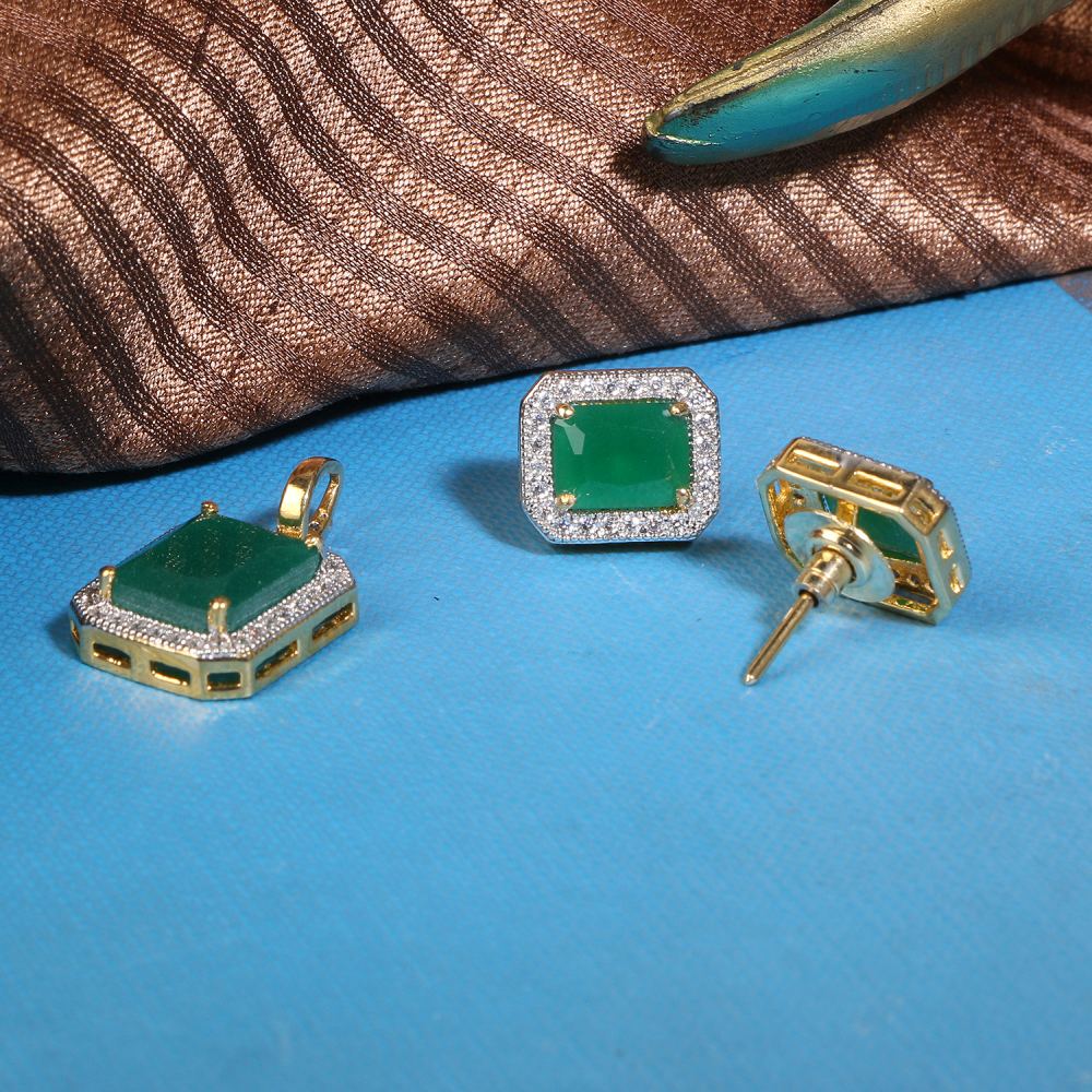 Gold jewelry set with square green gemstone and diamond halo, shown on a blue surface (ring and two earrings).