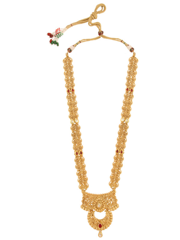Elaborate gold necklace with circular filigree beads and red gemstone accents, pendant at bottom.