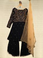 Black velvet dress with lace bodice on a hanger, paired with a sheer gold cape draped beside it on a light background, display style outfit.