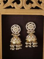 Pair of gold and pearl jhumka earrings with dangling beads on a dark background.
